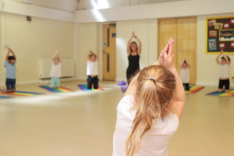children taking part in a yoga class